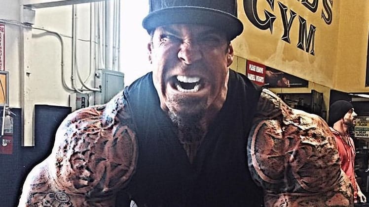 Rich Piana showing his arms at the gym