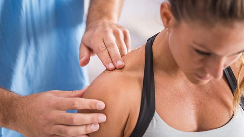 physical therapy therapist addressing trapezius muscle