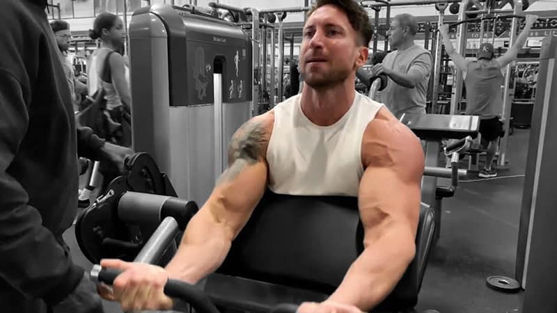 Troy performing a preacher curl using a machine