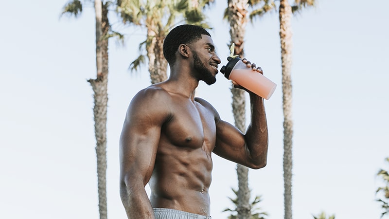 muscular man drinking a protein shake